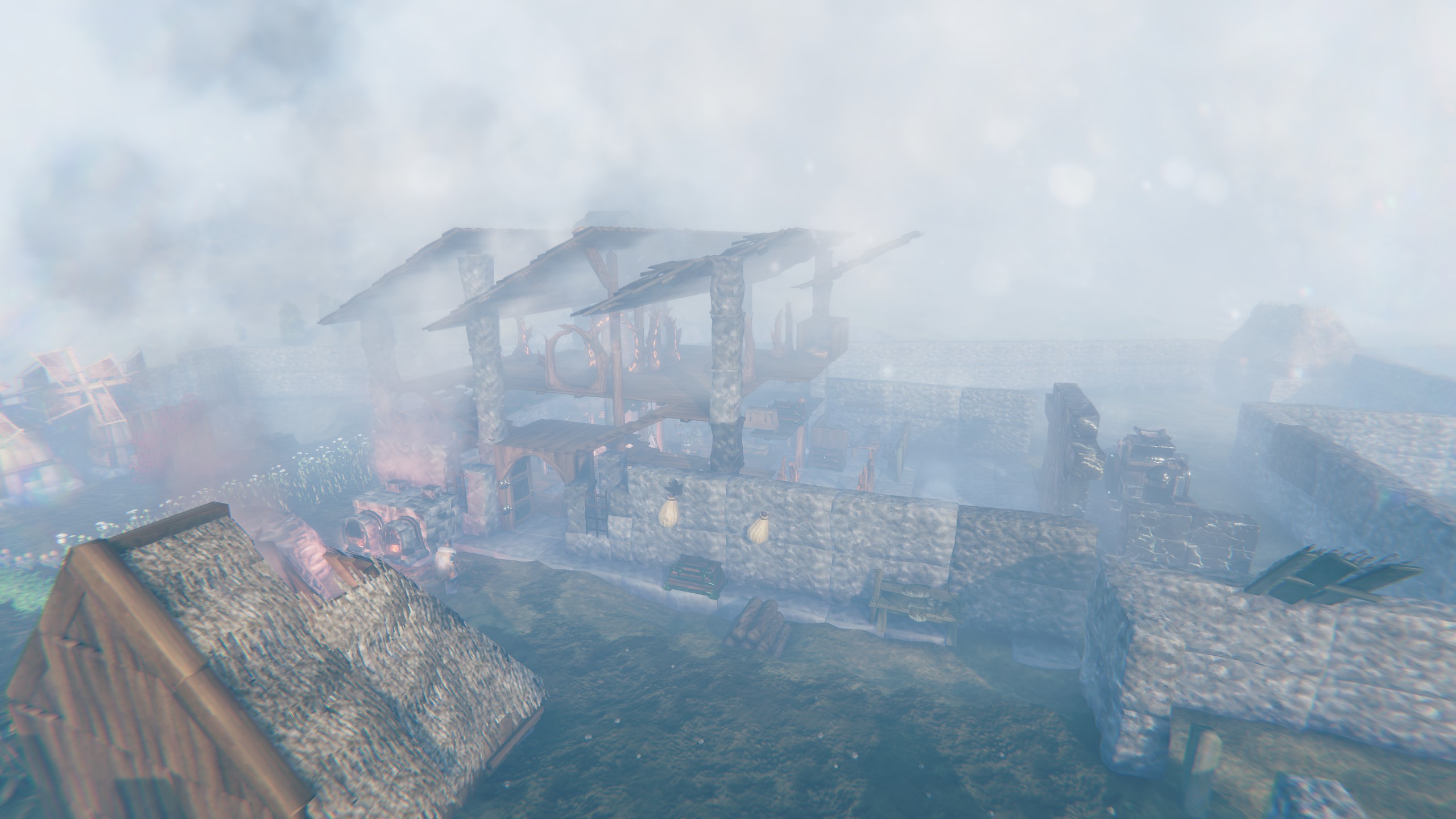 The Plains base in thick fog: a stone-and-timber hall with braziers, ringed by outer walls.